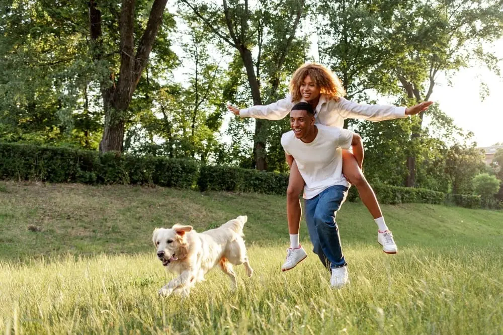 Couple running with dogs